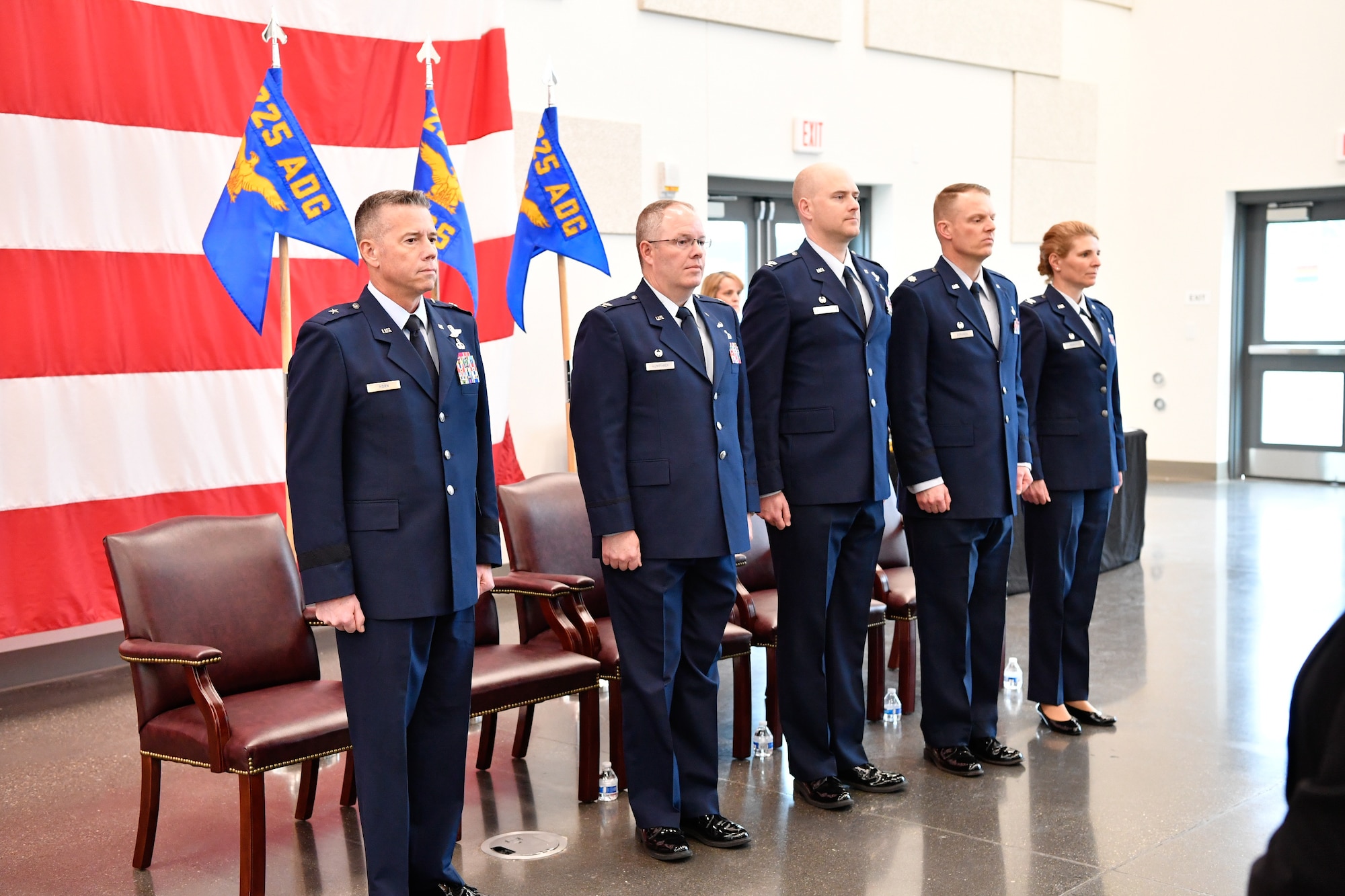 Members of the official party for the 225th Air Defense Group assumption of command ceremony stand at attention as the Western Air Defense Sector Honor Guard post the colors at the Pierce County Readiness Center, Camp Murray, Washington, April 10, 2019.  Pictured from left to right: Brig. Gen. Jeremy Horn, Washington Air National Guard commander, Col. Scott Humphrey, 225th Air Defense Group commander, Col. Brett Bosselmann, incoming 225th Support Squadron commander, Lt. Col. Brian Bergren, 225th Air Defense Squadron commander, and Col. Paige Abbott, outgoing 225th Support Squadron commander. (U.S. Air National Guard photo by Capt. Colette Muller)