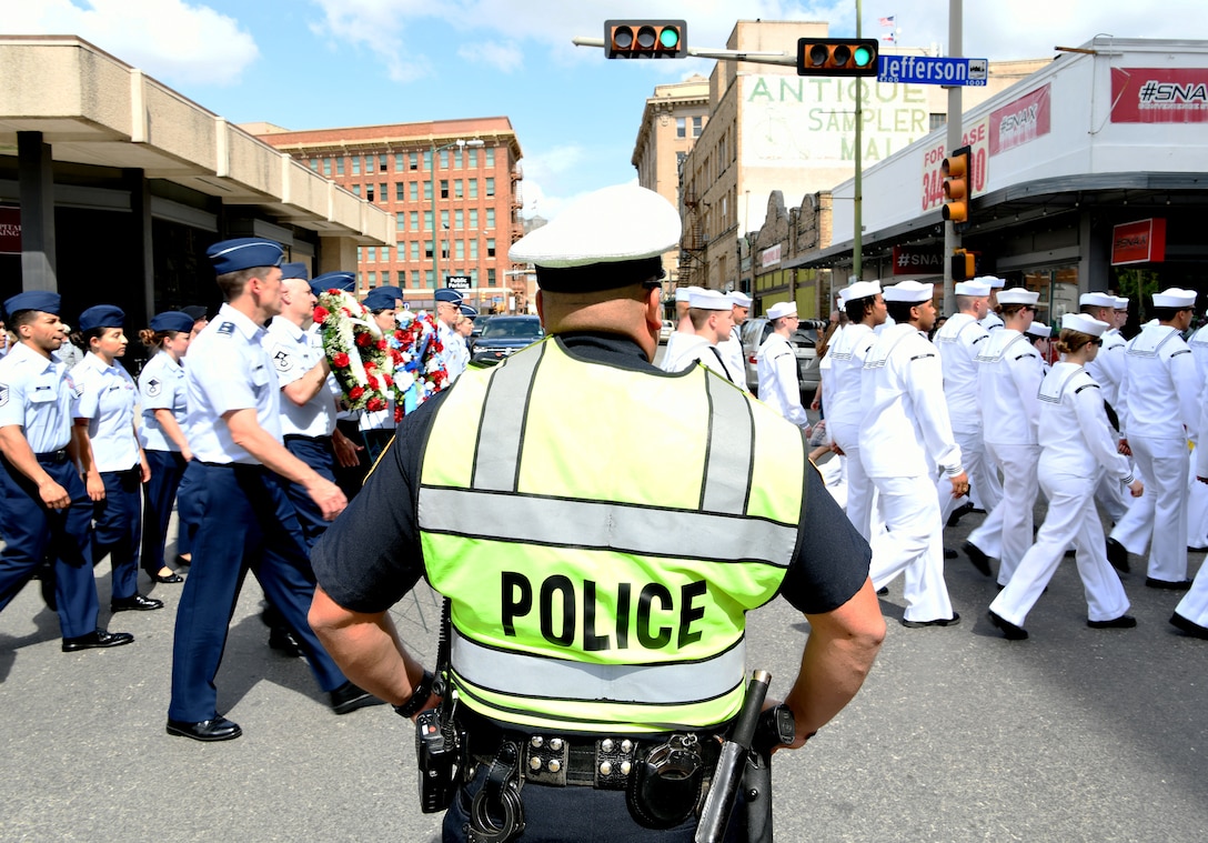 A police officer stops traffic as service members march in the Fiesta San Antonio “Pilgrimage to the Alamo” on April 22, 2019. Fiesta San Antonio is held annually to honor those who lost their lives at the Alamo and Battle of San Jacinto. (U.S. Air Force photo by Tech. Sgt. R.J. Biermann)