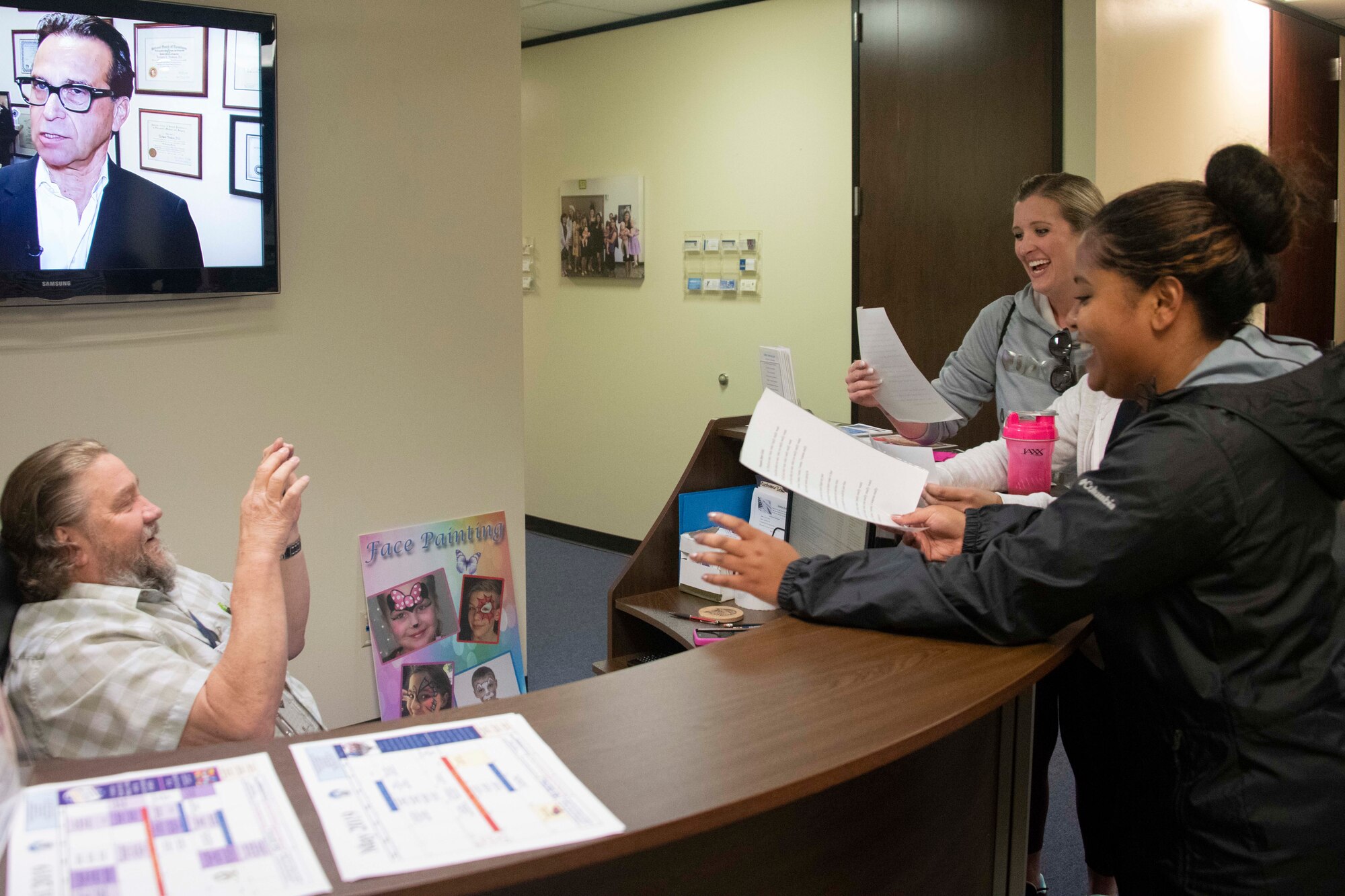 Members of the pink team of the Amazing SAPR (Sexual Assault Prevention & Response) Race scavenger hunt sing a song to receive their clue