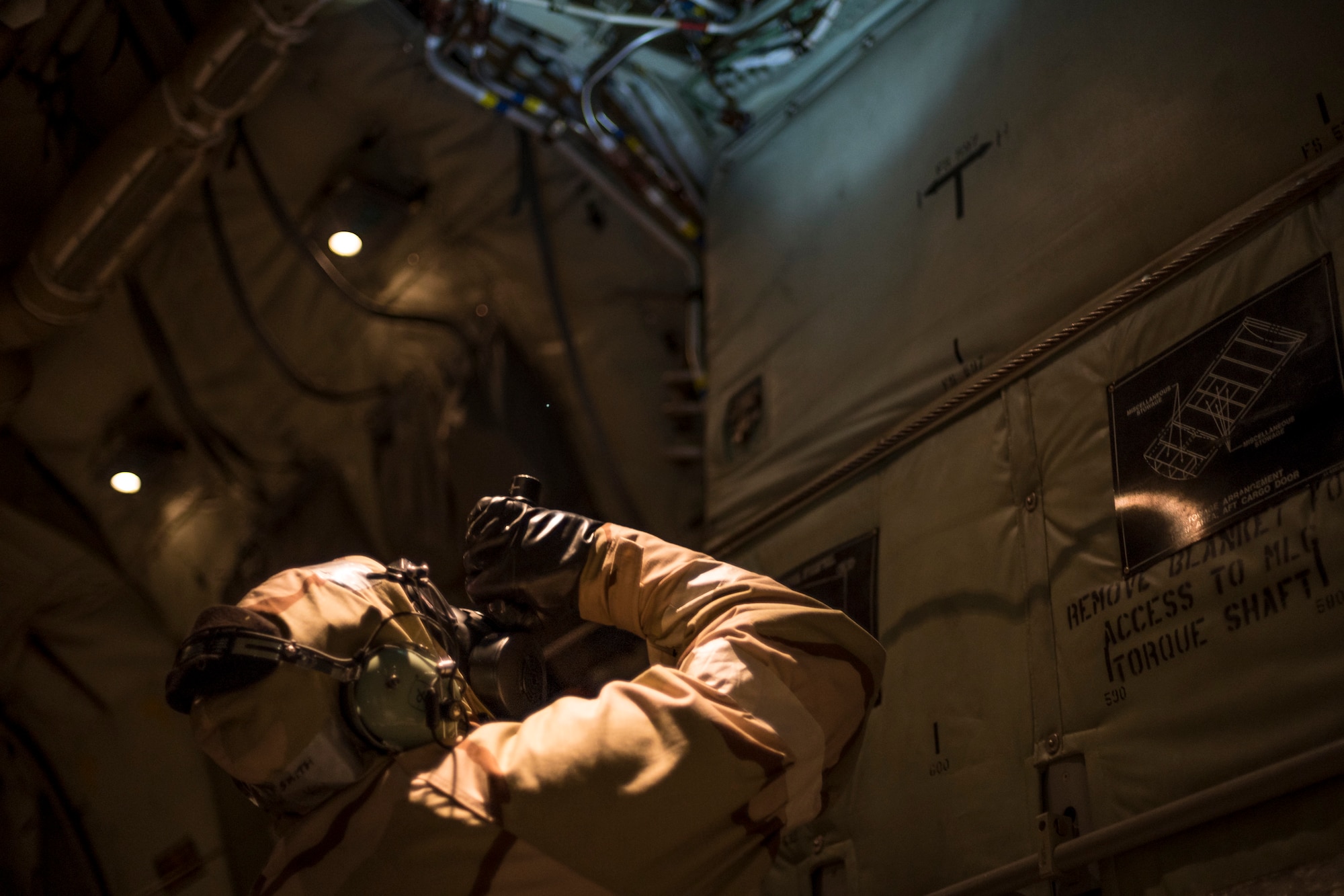 An Airman inspects the inside of an HC-130J Combat King II during exercise FT 19-04, April 19, 2019, at Moody Air Force Base, Ga. The five-day exercise will give base personnel an opportunity to experience contingency operations in a contested and degraded combat environment. During the exercise, personnel will be evaluated on how well they defend and recover the base from ground-opposition forces, as well as mortar and missile attacks while in MOPP gear. (U.S. Air Force photo by Airman 1st Class Hayden Legg)
