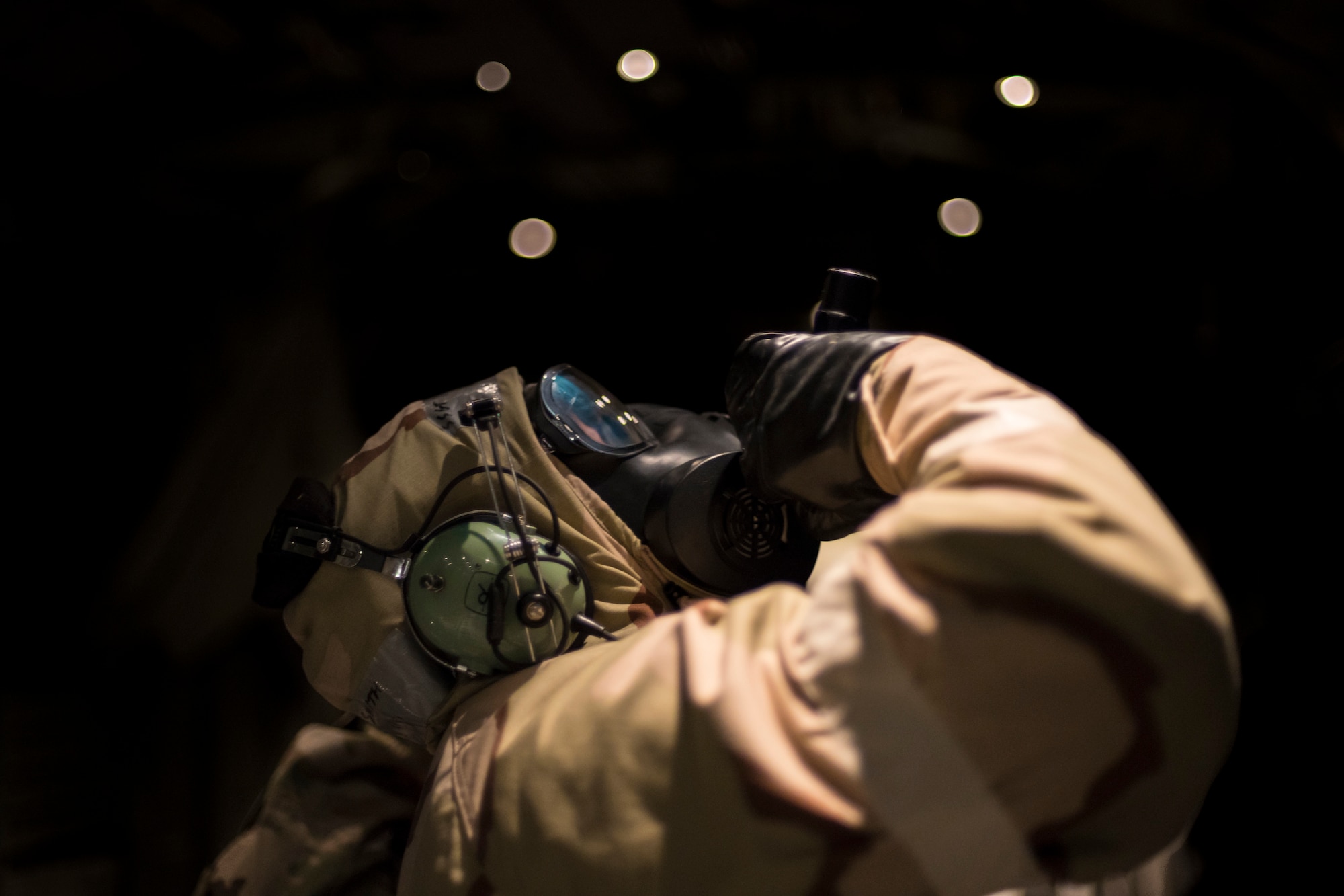 An Airman checks part of an HC-130J Combat King II during exercise FT 19-04, April 19, 2019, at Moody Air Force Base, Ga. The five-day exercise will give base personnel an opportunity to experience contingency operations in a contested and degraded combat environment. During the exercise, personnel will be evaluated on how well they defend and recover the base from ground-opposition forces, as well as mortar and missile attacks while in MOPP gear. (U.S. Air Force photo by Airman 1st Class Hayden Legg)