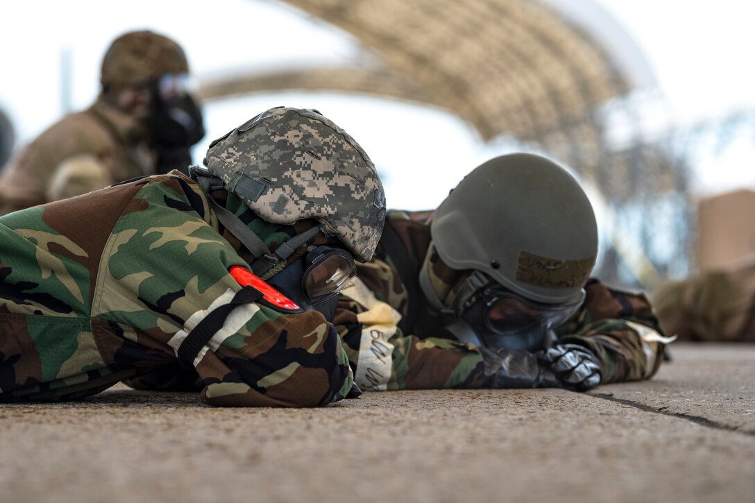 Airmen assigned to the 23d Aircraft Maintenance Squadron assume prone position in a simulated bunker during exercise FT 19-04, April 17, 2019, at Moody Air Force Base, Ga. The five-day exercise will give base personnel an opportunity to experience contingency operations in a contested and degraded combat environment. During the exercise, personnel will be evaluated on how well they defend and recover the base from ground-opposition forces, as well as mortar and missile attacks, while in mission oriented protective posture gear. (U.S. Air Force photo by Airman 1st Class Taryn Butler)