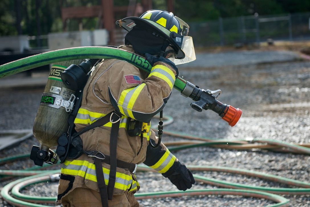 An Airman from the 23d Civil engineer Squadron performs hose lay operations during a structural live fire exercise during exercise FT 19-04, April 17, 2019, at Moody Air Force Base, Ga. The training simulated a structural fire, where the firefighters simultaneously extinguished a fire while rescuing simulated burn victims. The exercise focused on high operations tempo and the ability to survive and operate in a chemical, biological, radioactive and nuclear environment to meet Chief of Staff of the Air Force and the Commander of Air Combat Command’s intent for readiness. (U.S. Air Force photo by Senior Airman Erick Requadt)