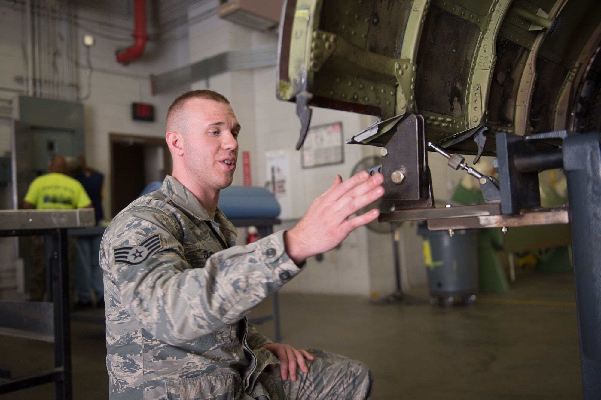 U.S. Air Force Staff Sgt. Quinn Smith, a sheet metal technician with the 116th Air Control Wing aircraft structural maintenance section, Georgia Air National Guard, explains the capabilities of the newly-created cowling fixture table April 3, 2019, at Robins AFB, Ga.