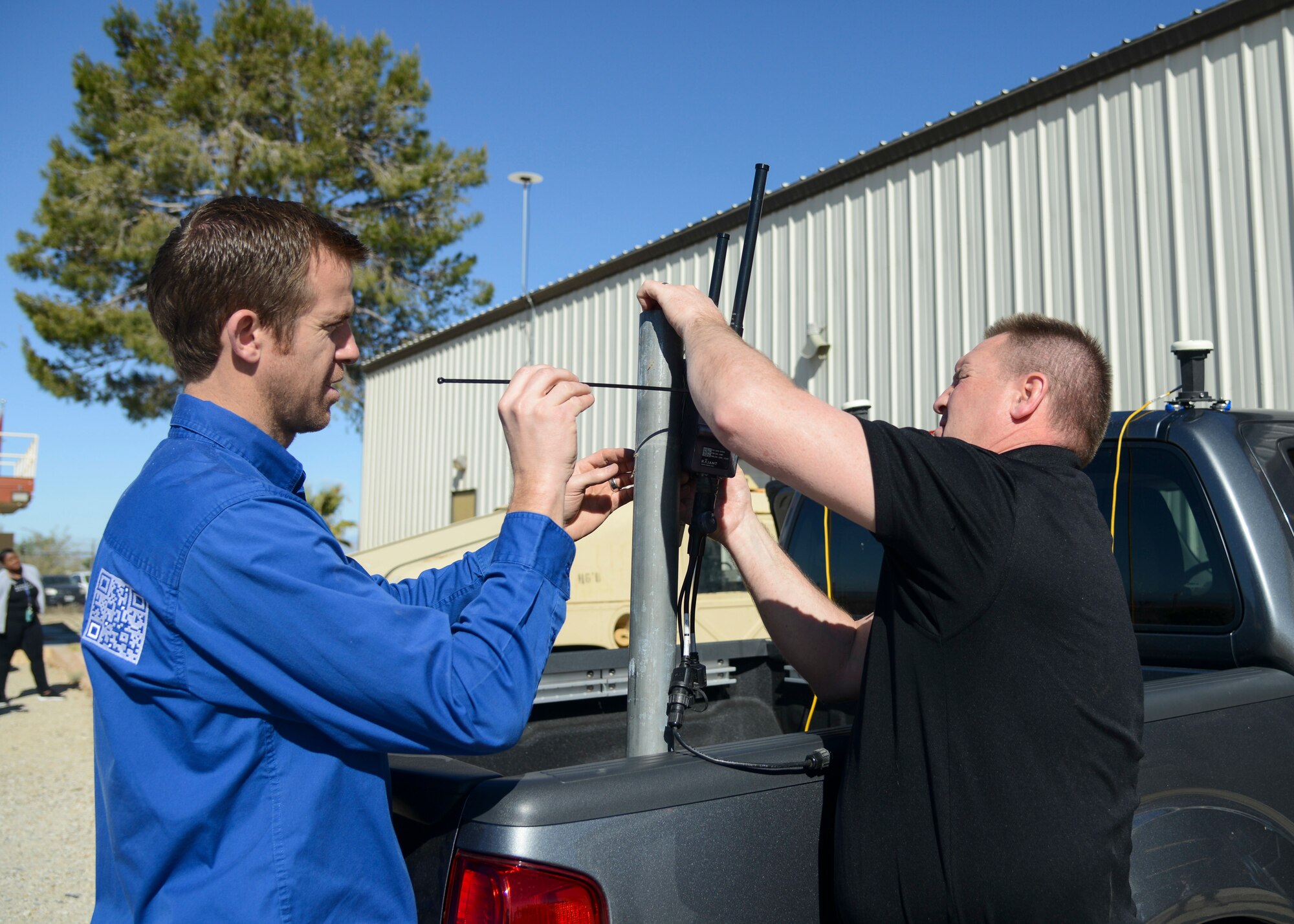 Technicians from Autonomous Solutions Inc. attach a radio antenna to a vehicle during a site survey to gather information needed to provide their autonomous services to the Precision Impact Range Area at Edwards Air Force Base, Calif., April 17. The collaboration between Team Edwards and ASI was born from the Air Force’s AFWERX and Small Business Innovation Research program which allows a faster process for new and emerging technology companies to showcase their products to the Air Force. (U.S. Air Force photo by Giancarlo Casem)