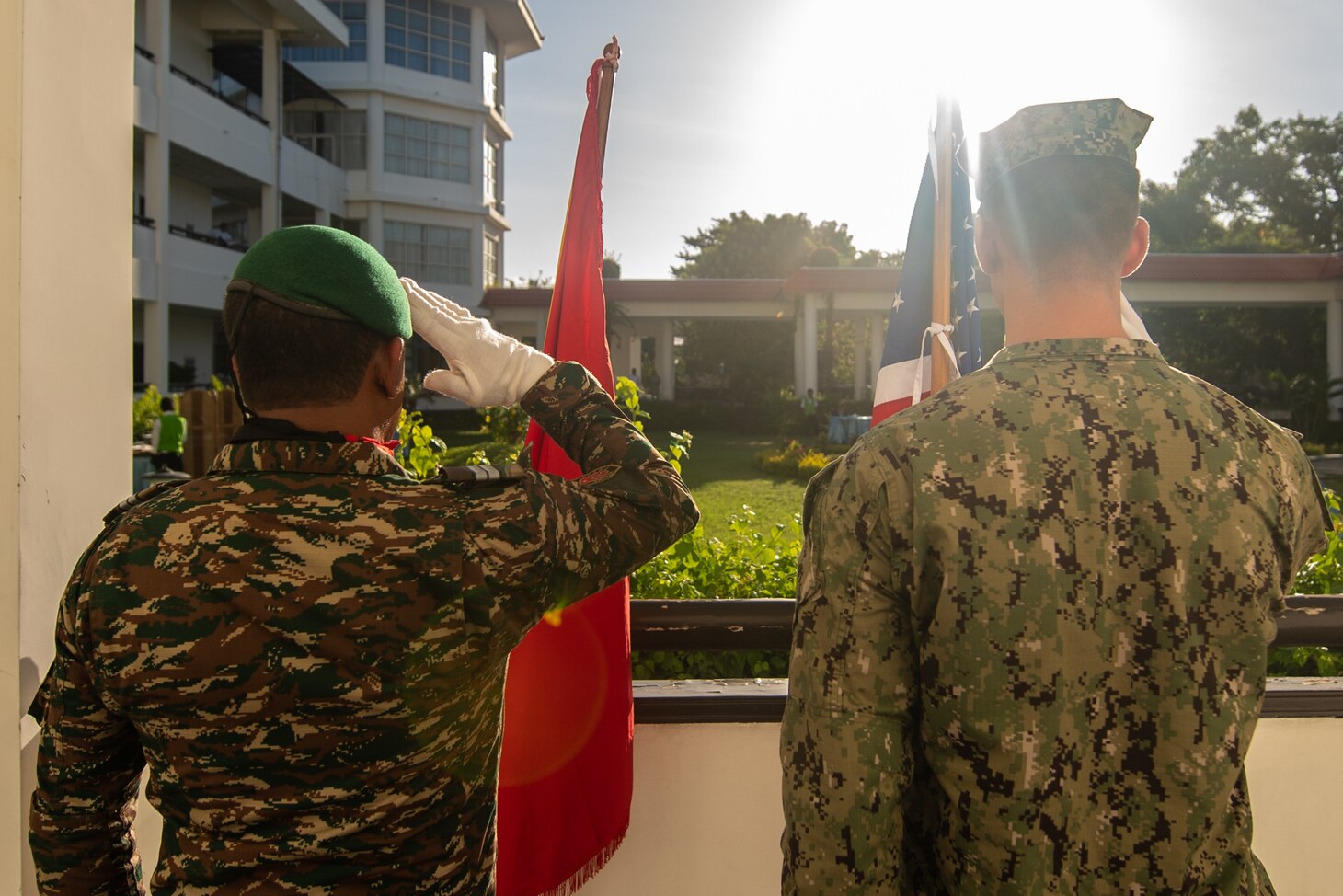 DILI, Timor-Leste (April 23, 2019) – Timor-Leste Defense Force Lt. Rufino Lima and U.S. Navy Hospital Corpsman Grayson Powell salute their respective ensigns during the Pacific Partnership 2019 opening ceremony for Timor-Leste. Pacific Partnership, now in its 14th iteration, is the largest annual multinational humanitarian assistance and disaster relief preparedness mission conducted in the Indo-Pacific. Each year the mission team works collectively with host and partner nations to enhance regional interoperability and disaster response capabilities, increase security and stability in the region, and foster new and enduring friendships in the Indo-Pacific.