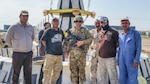 Staff Sgt. Bradley Owens, a combat medic with the West Virginia Army National Guard’s (WVARNG) Company C, 2-104th General Support Aviation Battalion, poses with Iraqi nationals during a tour of duty in Taji, Iraq, in 2016. Owens recently was able to apply his 68W training to assist a driver whose vehicle had careened off an interstate overpass in Parkersburg, W.Va.