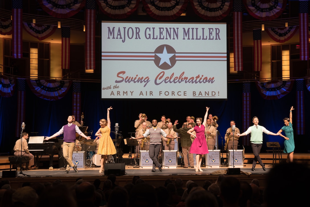 Members of The U.S. Air Force Band perform as dancers take center stage during "On the Air: A Glenn Miller Swing Celebration," a show featuring the music of big band legend Major Glenn Miller on April 2, 2019, at the Music Center at Strathmore in North Bethesda, Maryland. The U.S. Air Force Band partnered with Washington Performing Arts to present this concert highlighting the legacy of Major Miller's music and his leadership of the Army Air Force Band. This year marks the 75th anniversary of the disappearance of Miller's plane during World War II. (U.S. Air Force Photo by Technical Sgt. Valentine Lukashuk)