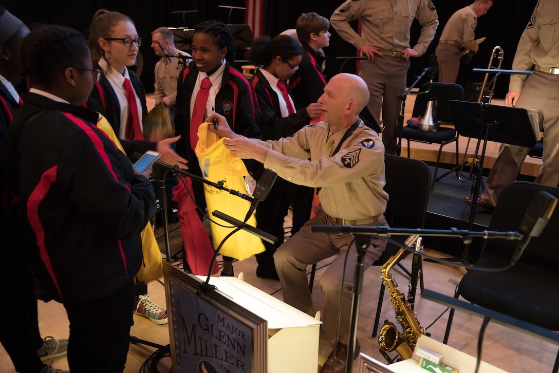 Senior Master Sgt. David Stump visits with audience members at the conclusion of "On the Air: A Glenn Miller Swing Celebration," a show featuring The U.S. Air Force Band performing the music of big band legend Major Glenn Miller on April 2, 2019, at the Music Center at Strathmore in North Bethesda, Maryland. The U.S. Air Force Band partnered with Washington Performing Arts to present this concert highlighting the legacy of Major Miller's music and his leadership of the Army Air Force Band. This year marks the 75th anniversary of the disappearance of Miller's plane during World War II. (U.S. Air Force Photo by Technical Sgt. Valentine Lukashuk)