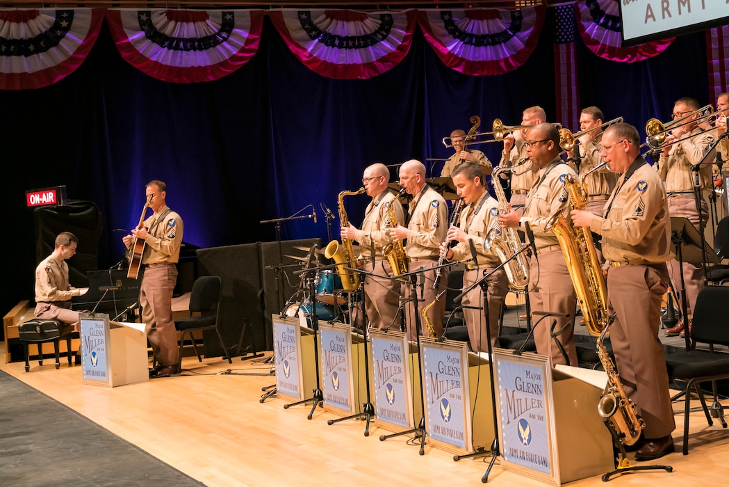 Members of The U.S. Air Force Band stand to perform the music of big band legend Major Glenn Miller at "On the Air: A Glenn Miller Swing Celebration," on April 2, 2019, at the Music Center at Strathmore in North Bethesda, Maryland. The U.S. Air Force Band partnered with Washington Performing Arts to present this concert highlighting the legacy of Major Miller's music and his leadership of the Army Air Force Band. This year marks the 75th anniversary of the disappearance of Miller's plane during World War II. (U.S. Air Force Photo by Master Sgt. Josh Kowalsky)