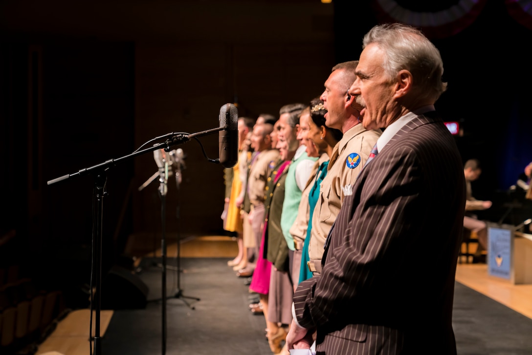 Washington Performing Arts Artist-in-Residence (and host of WAMU’s The Big Broadcast) Murray Horwitz (right) sings along with the entire cast of "On the Air: A Glenn Miller Swing Celebration," a show featuring The U.S. Air Force Band performing the music of big band legend Major Glenn Miller on April 2, 2019, at the Music Center at Strathmore in North Bethesda, Maryland. The U.S. Air Force Band partnered with Washington Performing Arts to present this concert highlighting the legacy of Major Miller's music and his leadership of the Army Air Force Band. This year marks the 75th anniversary of the disappearance of Miller's plane during World War II. (U.S. Air Force Photo by Master Sgt. Josh Kowalsky)