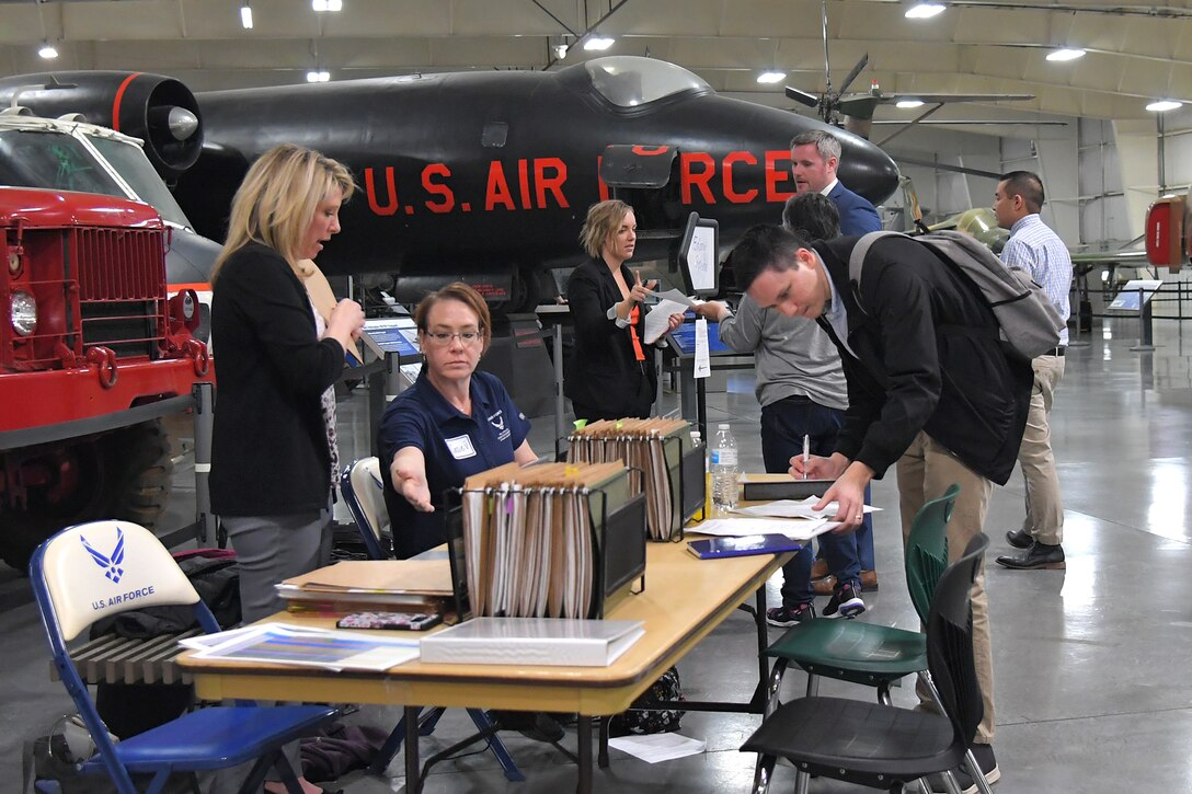 A prospective hire reviews paperwork during a job fair March 20, 2019, at Hill Air Force Base, Utah. The event held at the base’s museum focused on hiring civilian scientists and engineers. Due to workload growth and attrition of a senior workforce, Hill AFB is expecting to hire 200-300 scientists and engineers per year for the next few years. (U.S Air Force photo by Todd Cromar)