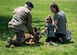 The Pontello family plays with U.S. Air Force Military Working Dog Max, 633rd Security Forces Squadron explosives detector at Joint Base Langley-Eustis, Virginia, April 23, 2019.