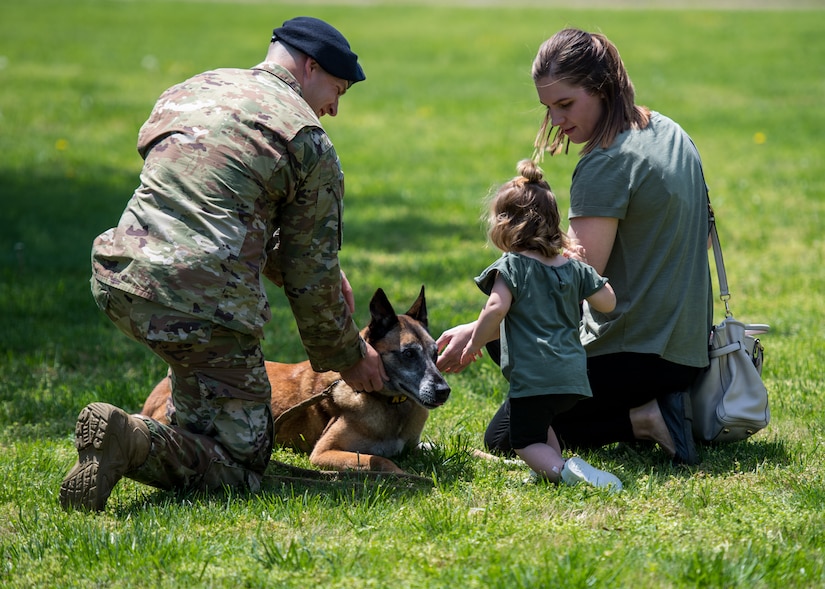 The Pontello family plays with U.S. Air Force Military Working Dog Max, 633rd Security Forces Squadron explosives detector at Joint Base Langley-Eustis, Virginia, April 23, 2019.