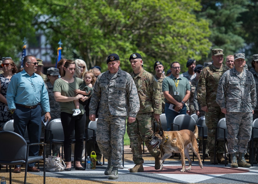 The official party walks in for a retirement ceremony in honor of U.S. Air Force Military Working Dog Max, 633rd Security Forces Squadron explosives detector at Joint Base Langley-Eustis, Virginia, April 23, 2019.