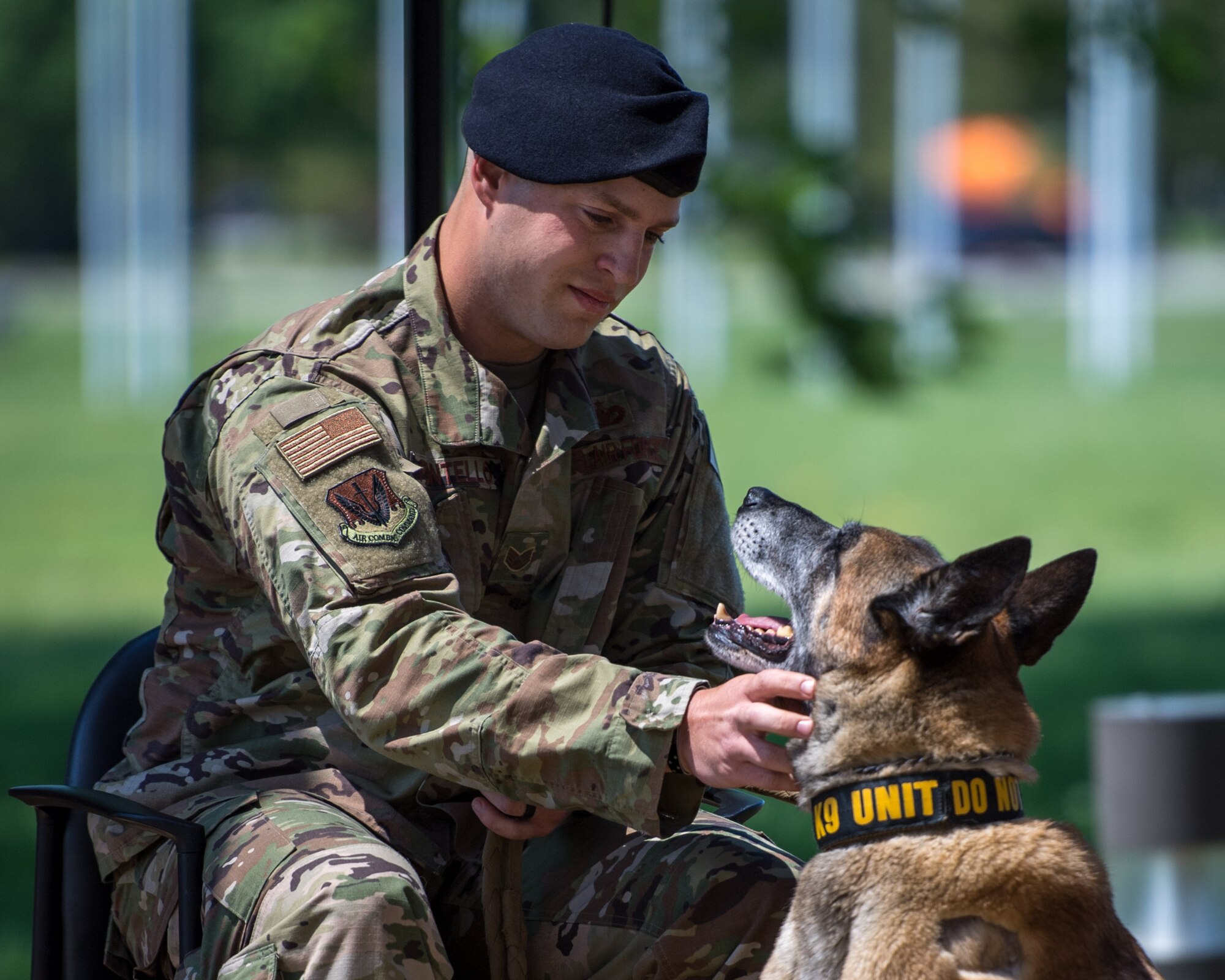 U.S. Air Force Staff Sgt. Carmen Pontello, 633rd Security Forces Squadron military working dog handler gazes at Military Working Dog Max, 633rd SFS explosives detector, during Max’s retirement at Joint Base Langley-Eustis, Virginia, April 23, 2019.