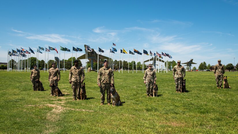(Center) U.S. Air Force Military Working Dog Max, 633rd Security Forces Squadron explosives detector, takes a last group photo with his brothers at arms at Joint Base Langley-Eustis, Virginia, April 23, 2019.