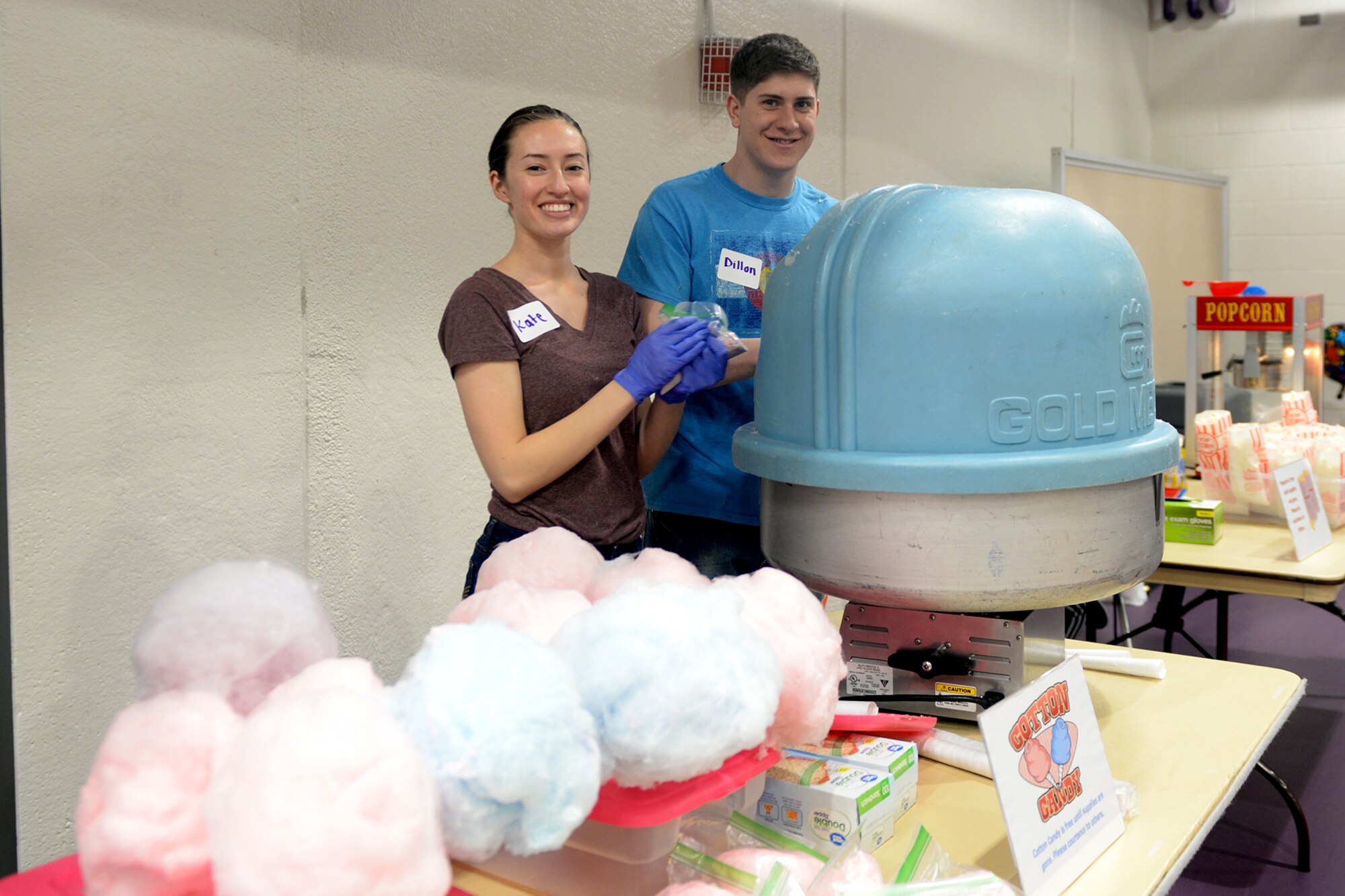 Airman 1st Class Kate Gatsios, 55th Medical Group, and Airman 1st Class Dillon Kline, 55th Logistics Readiness Squadron, make cotton candy April 9, 2019, at the Bellevue Lied Center, Nebraska. The center was used for the 6th Annual Special Needs Fair. (U.S. Air Force photo by Kendra Williams)