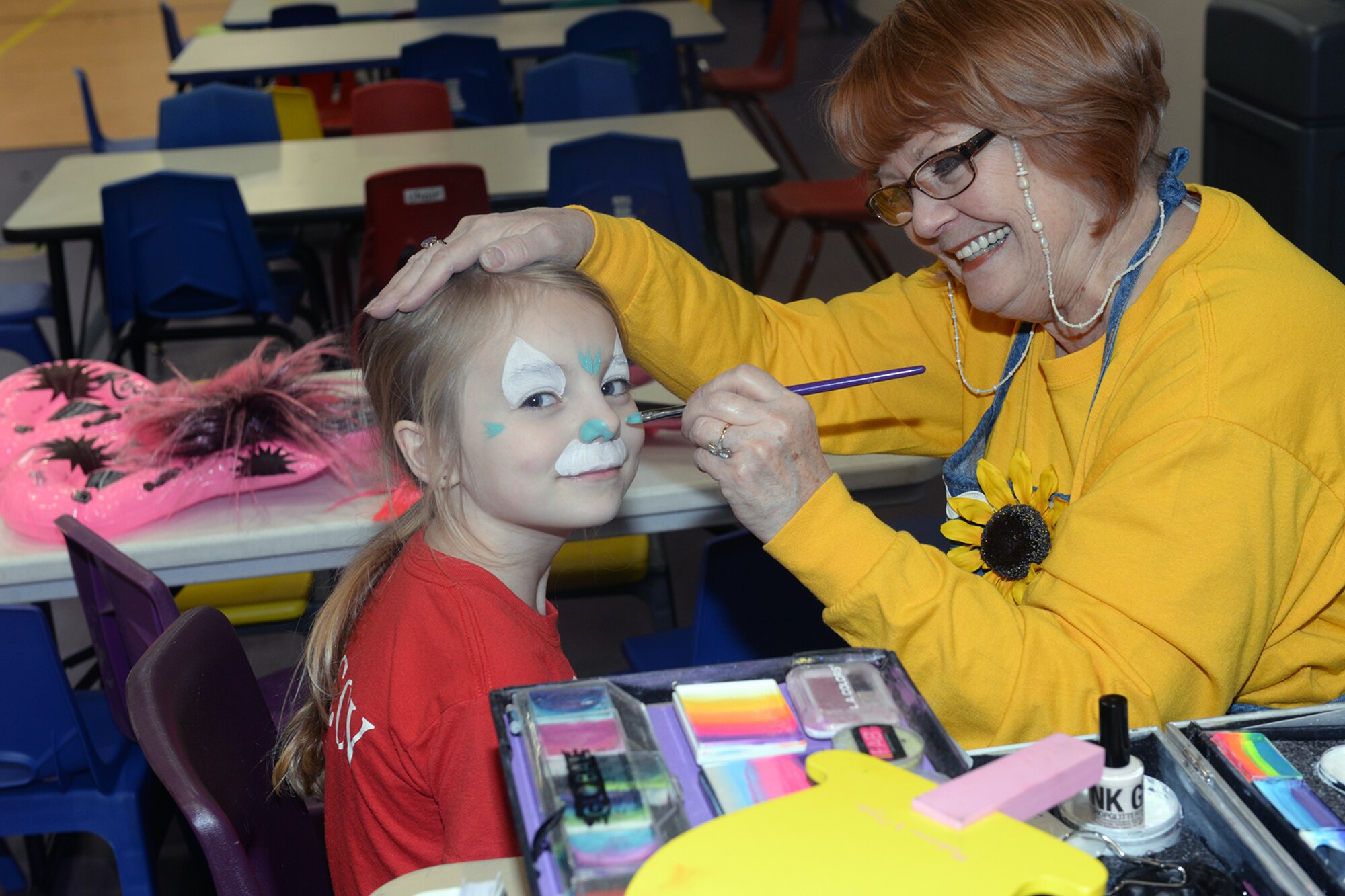 Ruth Merwald, Giggles the clown, paints a child’s face April 9, 2019 at the Bellevue Lied Center, Nebraska. The 6th Annual Special Needs Fair also offered food and vendors. (U.S. Air Force photo by Kendra Williams)