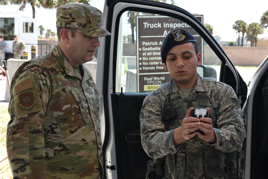 Brig Gen Doug Schiess, 45th Space Wing commander, meets with Airman 1st Class Isaiah Bermudez, 45th Security Forces Squadron installation entry controller, at Patrick Air Force Base, Fla., April 16, 2019. Schiess visited the 45th SFS to learn about new capabilites, and to be immersed in the Security Forces mission. (U.S. Air Force photo by Airman 1st Class Dalton Williams)