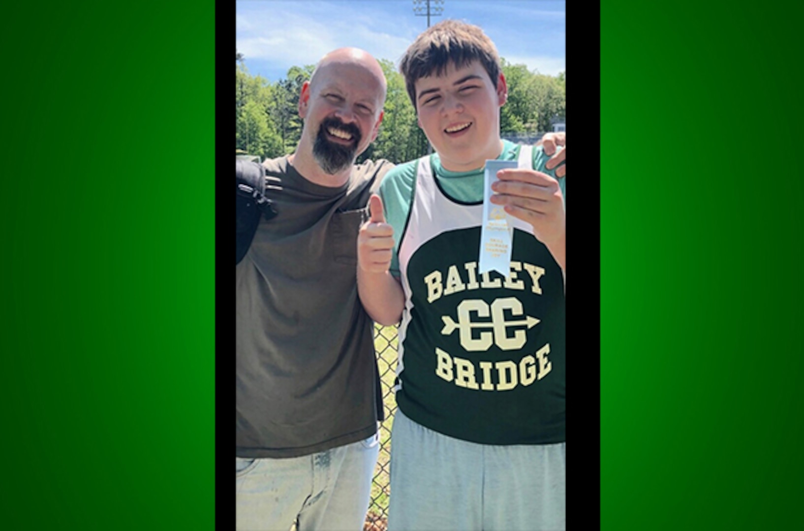 Christian poses with ribbon and dad