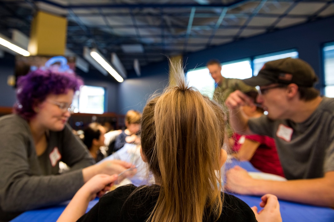 Participants eat together during a deployed spouse dinner, April 23, 2019, at Moody Air Force Base, Ga. The dinner served as an opportunity for the families of deployed members to bond and provide relief. The mission’s success depends on resilient Airmen and families, who are prepared to make sacrifices with the support of their fellow Airmen, local communities and leadership. (U.S. Air Force photo by Senior Airman Erick Requadt)