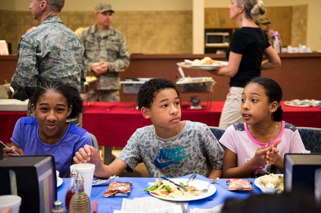 Participants eat and socialize during a deployed spouse dinner, April 23, 2019, at Moody Air Force Base, Ga. The dinner served as an opportunity for the families of deployed members to bond and provide relief. The mission’s success depends on resilient Airmen and families, who are prepared to make sacrifices with the support of their fellow Airmen, local communities and leadership. (U.S. Air Force photo by Senior Airman Erick Requadt)