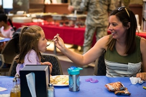 A participant feeds her child during a deployed spouse dinner, April 23, 2019, at Moody Air Force Base, Ga. The dinner served as an opportunity for the families of deployed members to bond and provide relief. The mission’s success depends on resilient Airmen and families, who are prepared to make sacrifices with the support of their fellow Airmen, local communities and leadership. (U.S. Air Force photo by Senior Airman Erick Requadt)