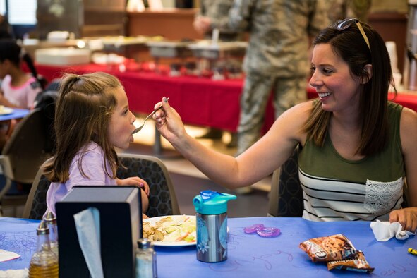 A participant feeds her child during a deployed spouse dinner, April 23, 2019, at Moody Air Force Base, Ga. The dinner served as an opportunity for the families of deployed members to bond and provide relief. The mission’s success depends on resilient Airmen and families, who are prepared to make sacrifices with the support of their fellow Airmen, local communities and leadership. (U.S. Air Force photo by Senior Airman Erick Requadt)