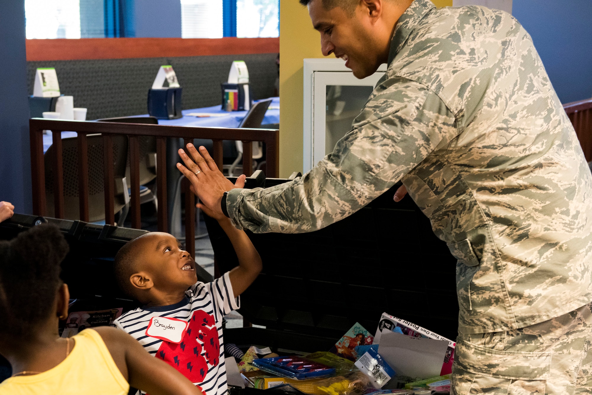 Lt. Col. Gregory Savella, 23d Force Support Squadron commander, high-fives a participant during a deployed spouse dinner, April 23, 2019, at Moody Air Force Base, Ga. The dinner served as an opportunity for the families of deployed members to bond and provide relief. The mission’s success depends on resilient Airmen and families, who are prepared to make sacrifices with the support of their fellow Airmen, local communities and leadership. (U.S. Air Force photo by Senior Airman Erick Requadt)