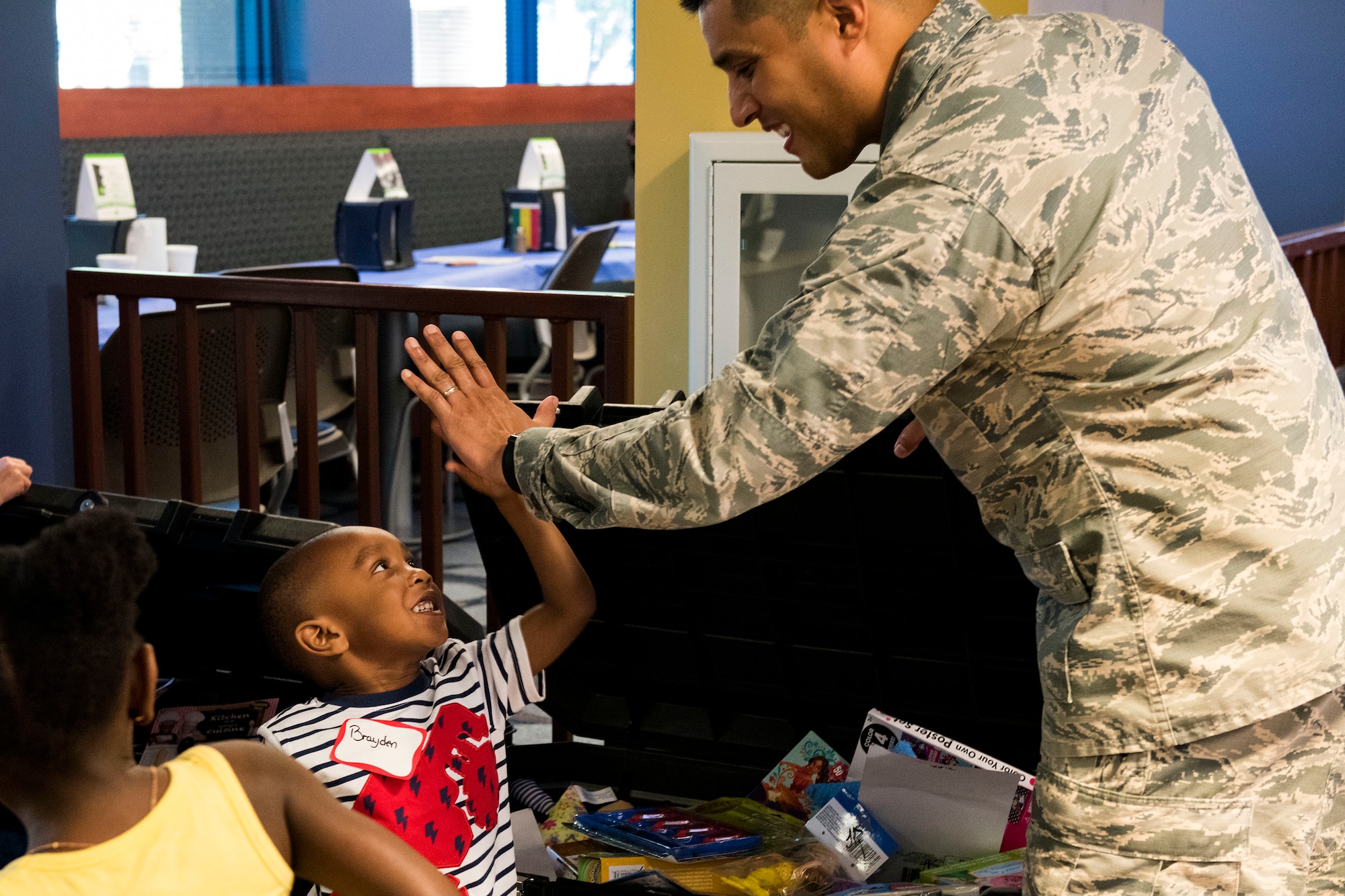 Lt. Col. Gregory Savella, 23d Force Support Squadron commander, high-fives a participant during a deployed spouse dinner, April 23, 2019, at Moody Air Force Base, Ga. The dinner served as an opportunity for the families of deployed members to bond and provide relief. The mission’s success depends on resilient Airmen and families, who are prepared to make sacrifices with the support of their fellow Airmen, local communities and leadership. (U.S. Air Force photo by Senior Airman Erick Requadt)