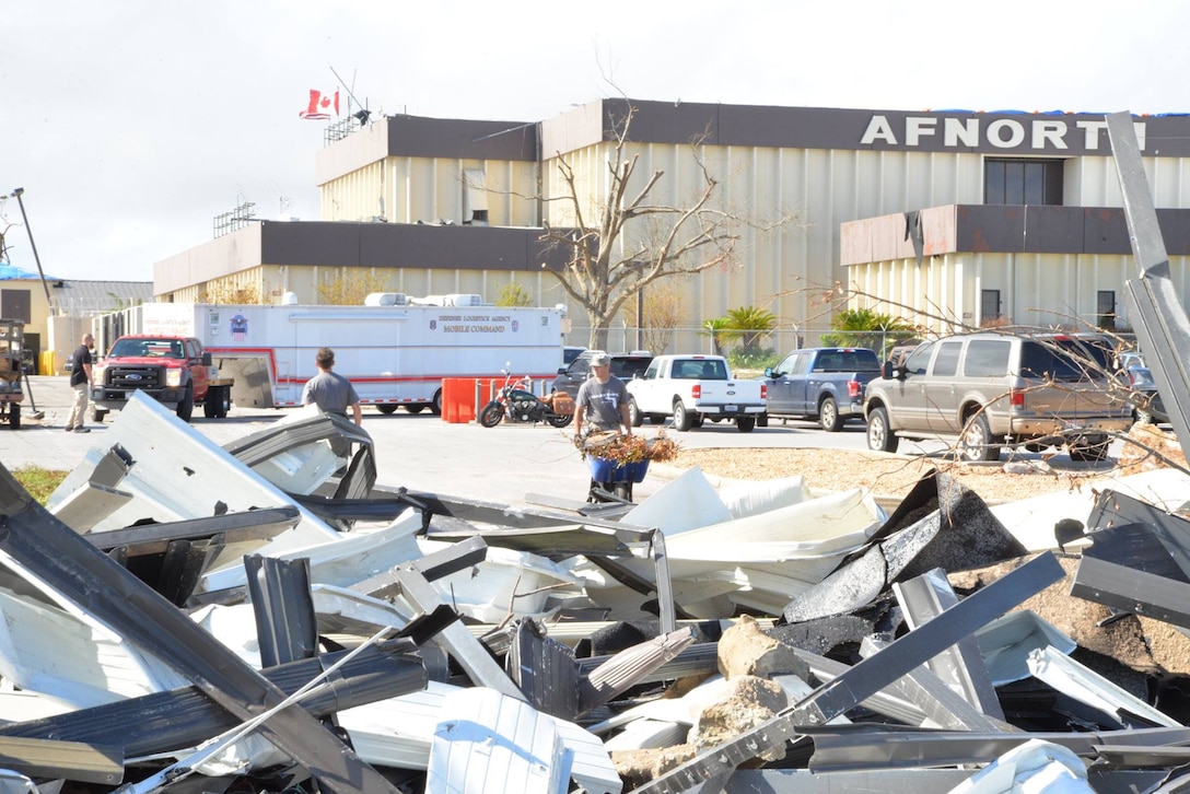 Members of the 601st Air Operations Center clean up debris outside the main building after being hit by Hurricane Michael, a category five storm that ravaged Tyndall Air Force Base, Fla., and the surrounding area, Bay County. The aggressive recovery effort to bring the Operation Noble Eagle mission back to Tyndall – 72 days – was highlighted in the Partridge-Slemon Award citation given to CONR as the 2018 recipient of the award. (U.S. Air National Guard photo by Maj. Andrew Scott)