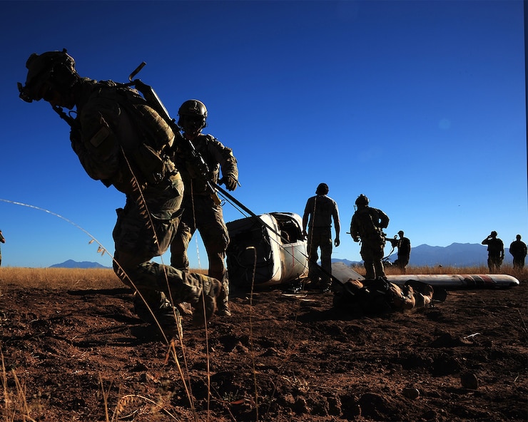 A photo of Airmen dragging equipment through the desert