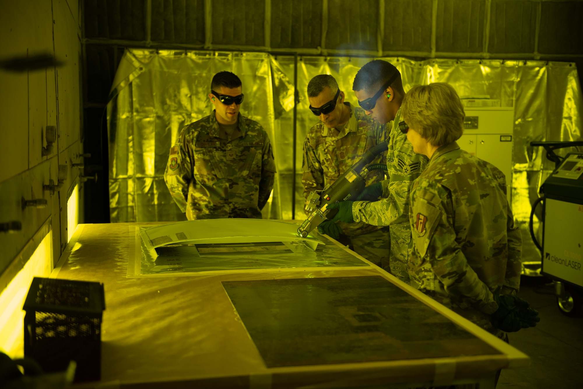 U.S. Air Force Gen. Maryanne Miller, Air Mobility Command commander and Chief Master Sgt. Terrence Greene, AMC command chief, watch a laser demonstration by Senior Airman Levi Gordon, 60th Maintenance Squadron aircraft structural maintenance apprentice, during a base tour at Travis Air Force Base, Calif., April 17, 2019. During their four-day visit, Miller and Greene met with Airmen across Travis to see how the base enhances AMC’s global mobility capabilities. (U.S. Air Force photo by Tech. Sgt. James Hodgman)