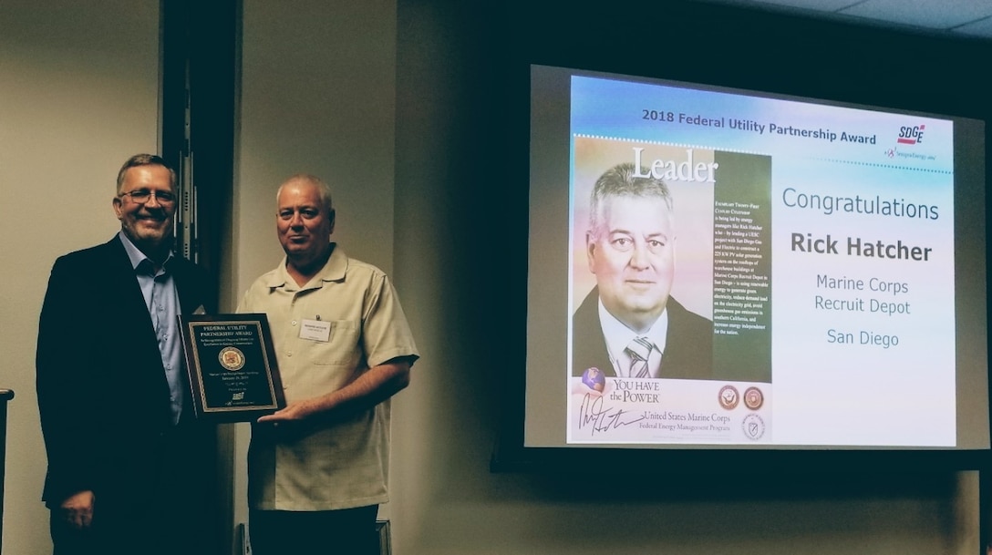 Joe Pierzina, Federal Accounts Manager, San Diego Gas & Electric Company, presents Rick Hatcher, Installation Energy Manager, Marine Corps Recruit Depot San Diego, with the 2018 Federal Utility Partnership Award on March 7, 2019. Photo courtesy of SDG&E.