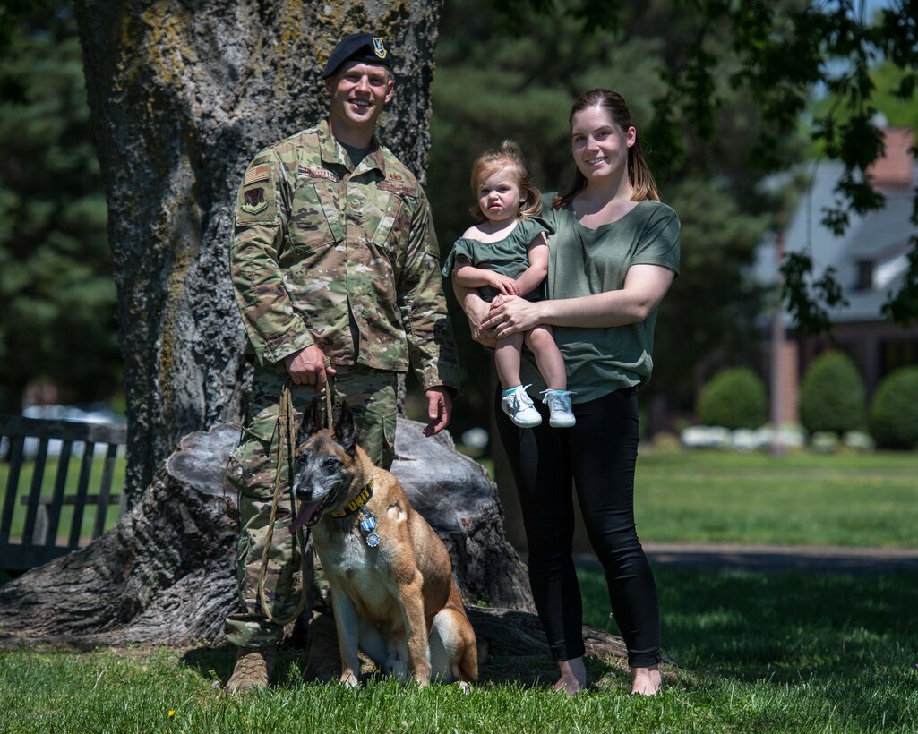 U.S. Air Force Military Working Dog Max, 633rd Security Forces Squadron explosives detector, joins the Pontello family for a family photo at Joint Base Langley-Eustis, Virginia, April 23, 2019.