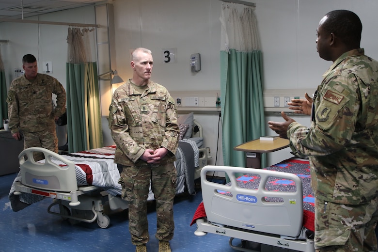 Along the Path of the Patient tour at the Craig Joint Theater Hospital in Bagram, Command Sergeant Major Brad Houston gets a brief about one of the comfort rooms for patients.