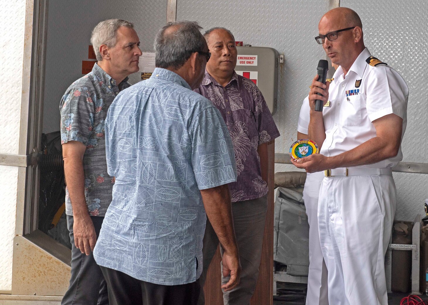CHUUK, Federated States of Micronesia (April 25, 2019) Royal Navy Capt. Paddy Allen, director of mission, presents His Excellency President Peter Christian, president of the Federated States of Micronesia, with a Pacific Partnership medallion at the closing ceremony aboard the Military Sealift Command expeditionary fast transport ship USNS Brunswick (T-EPF 6), strengthening strategic partnerships during Pacific Partnership 2019. Pacific Partnership, now in its 14th iteration, is the largest annual multinational humanitarian assistance and disaster relief preparedness mission conducted in the Indo-Pacific.