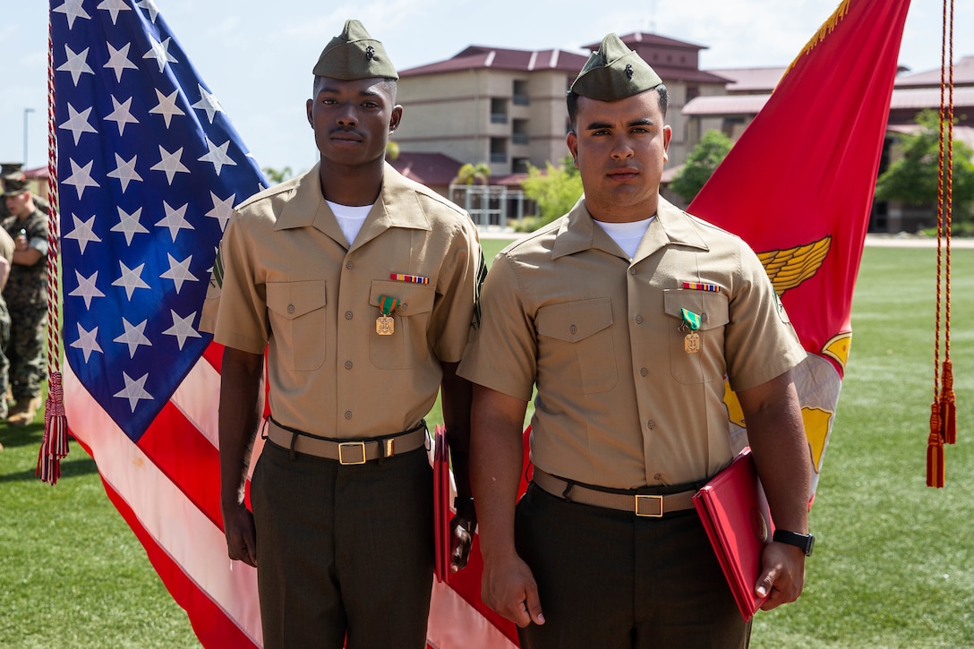 U.S. Marine Corps Cpl. Renzel Craft, left, and Cpl. Everton Porto, both heavy equipment mechanics with 1st Combat Engineer Battalion, 1st Marine Division, receive Navy and Marine Corps Achievement Medals during their Corporal Course graduation ceremony at Marine Corps Base Camp Pendleton, California, April 12, 2019. Craft and Porto received recognition for responding to an incident in the chow hall where a Marine was having a seizure.