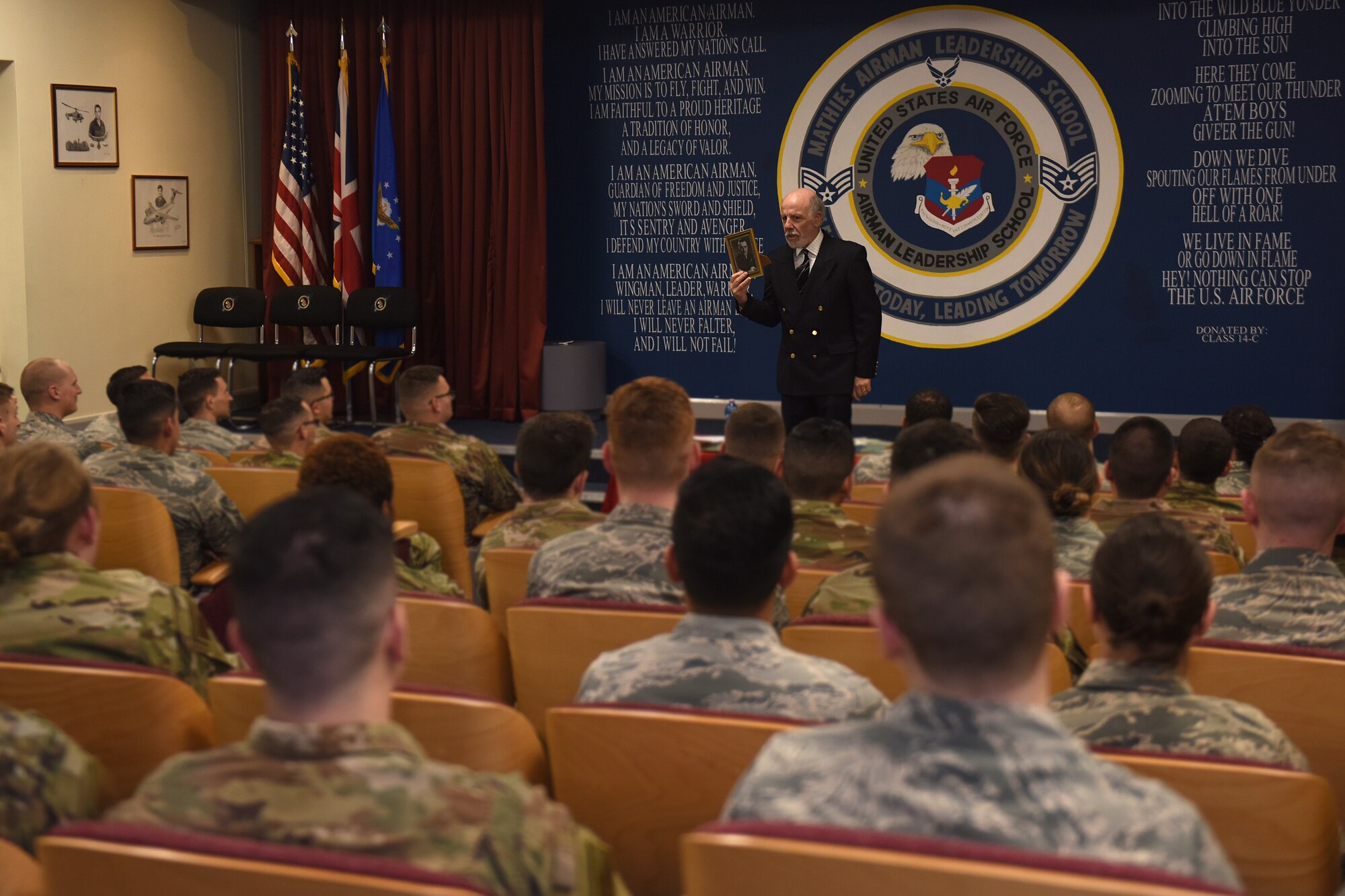 Peter Walmsley, 48th Security Forces Squadron honorary commander, speaks to an Airman Leadership School class at Royal Air Force Feltwell, England, April 16, 2019. Walmsley spoke to the future noncommissioned officers about his late father who served in World War II. (U.S. Air Force photo by Airman 1st Class Madeline Herzog)