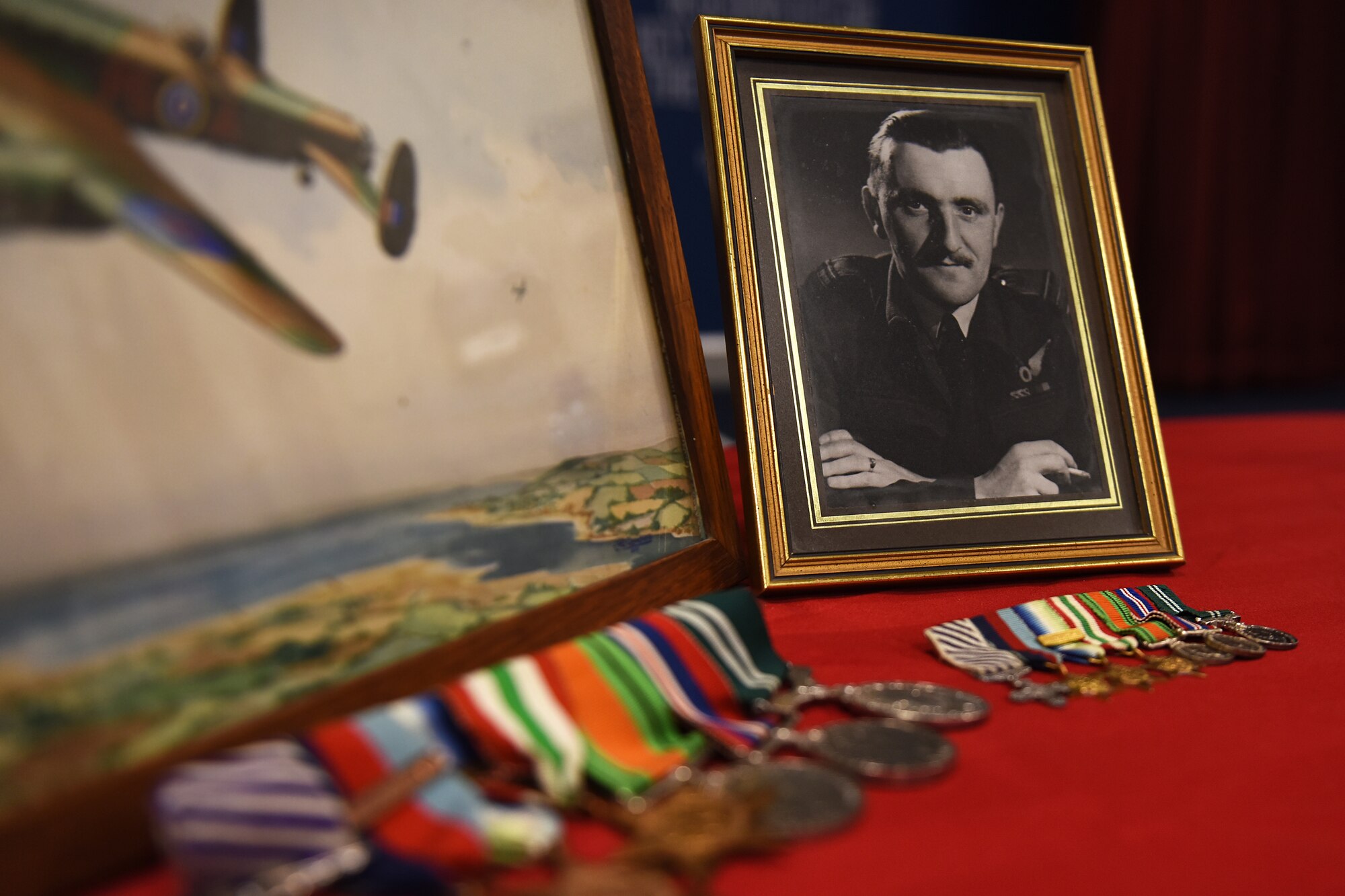 Medals and a photo of Peter Walmsley’s father, a World War II veteran, are displayed at Royal Air Force Feltwell, England, April 16, 2019. Walmsley is the 48th Security Forces Squadron honorary commander, and spoke to students about his father’s war history at the Mathies Airman Leadership School. (U.S. Air Force photo by Airman 1st Class Madeline Herzog)