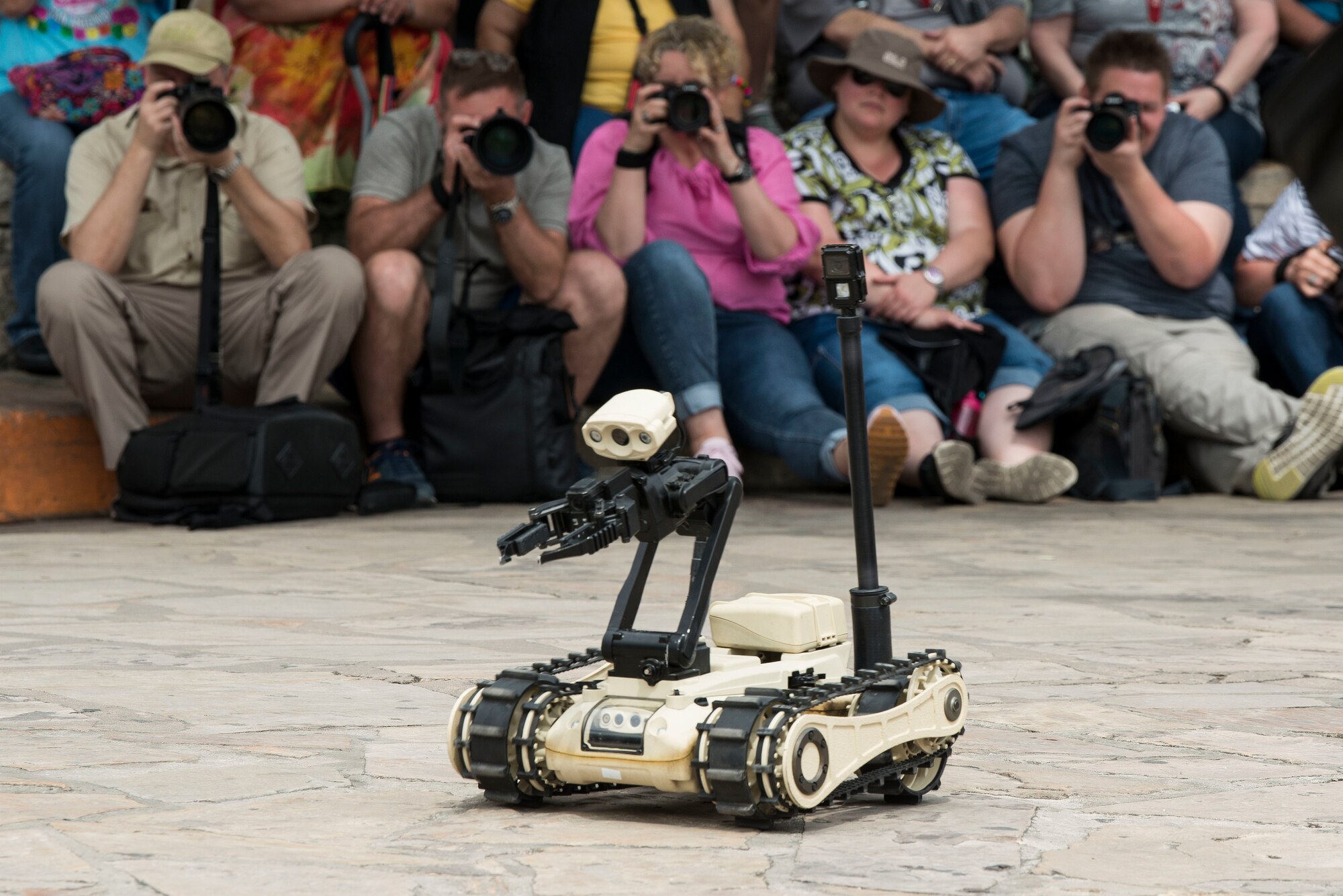 A robot used by the 502nd Civil Engineer Squadron, Explosive Ordnance Disposal, moves in front the audience during equipment and methods for bomb detection and disposal demonstration during San Antonio’s Fiesta Air Force Day at the Alamo, April 22, 2019. From its beginning in 1891, Fiesta has grown into an annual celebration that includes civic and military observances, street and river parades, exhibits, pilgrimages and memorials.