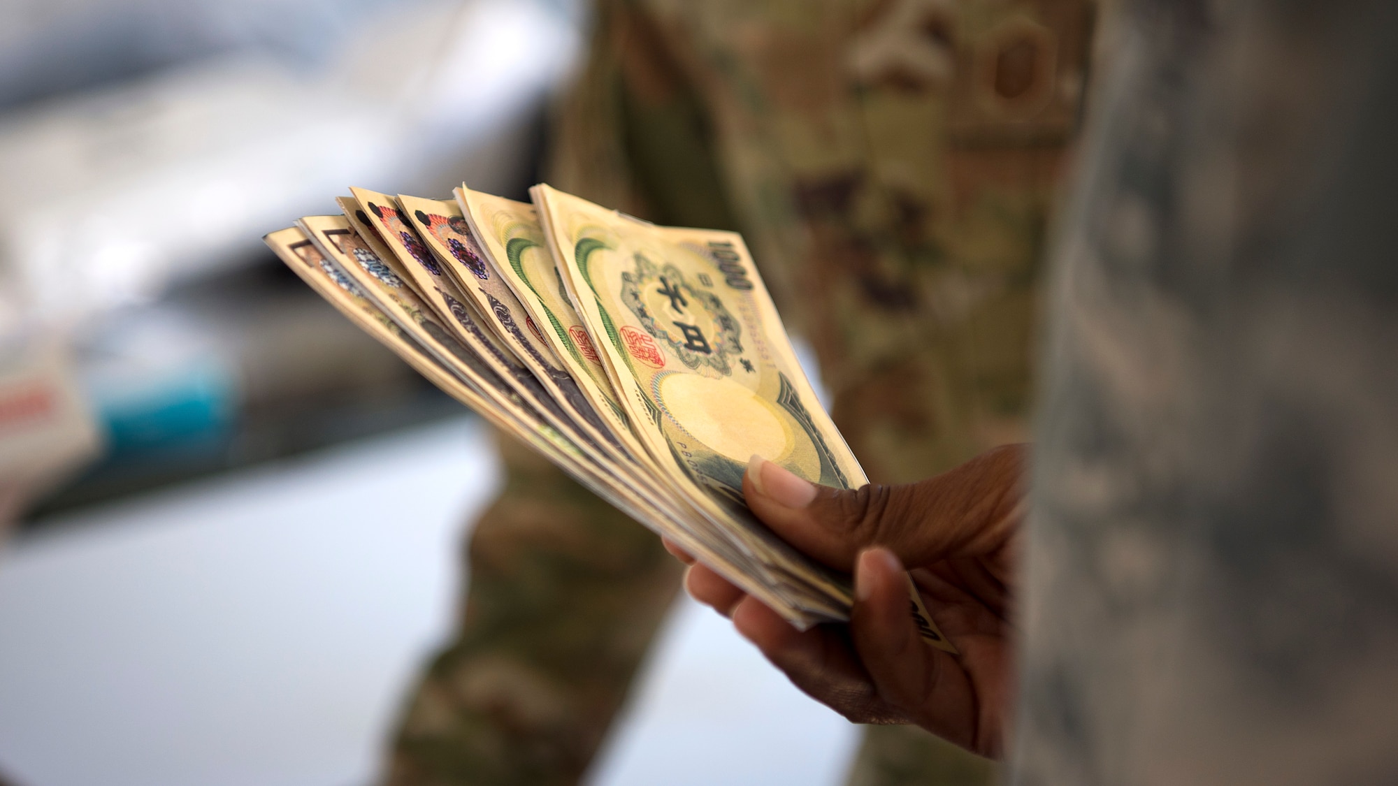 Airmen from the 6th Contracting Squadron at MacDill Air Force Base, Fla., exchange currency during the Operation Open Horizon training exercise April 16, 2019. The 6th CONS partnered with the 6th Comptroller Squadron in a simulated deployment to a forward operating base being stood up to deter a fictional aggressor.