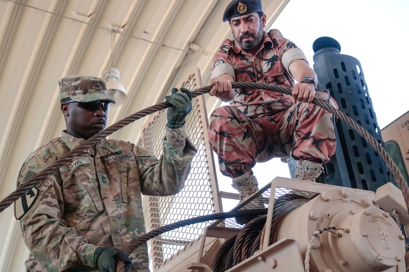 U.S. Army Sgt. 1st Class Josheph Davis assists Warrant Officer Sultan Salim Alaamari, Royal Army of Oman, with correcting a deficiency during the Heavy Equipment Transporter System Subject Matter Exchange II held at Sultan bin Safy Camp Shafa Oman, April 6-11, 2019.