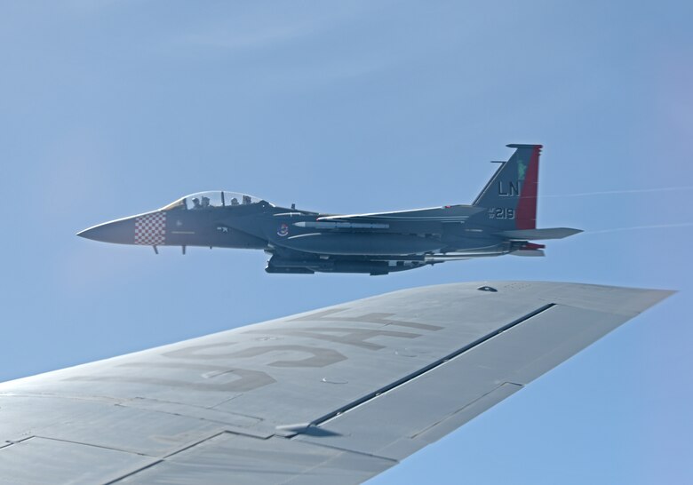 An F-15E Strike Eagle assigned to the 48th Fighter Wing at RAF Lakenheath, England, painted in the heritage colors of its World War II P-47 Thunderbolt predecessor, flies next to a KC-135 Stratotanker of the 351st Air Refueling Squadron at RAF Mildenhall during the “FURIOUS 48” readiness exercise over the skies of England, April 24, 2019. The exercise was designed to emphasize the importance of combat skills effectiveness training and test 100th ARW and 48th FW Airmen on their ability to survive and operate in wartime conditions. (U.S. Air Force photo by Airman 1st Class Brandon Esau)