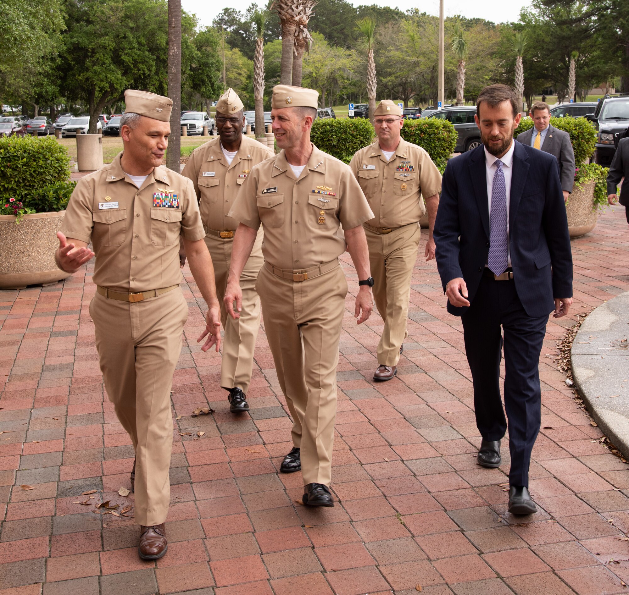 Naval Information Warfare Center Atlantic Commanding Officer Capt. Wesley Sanders, left, chats with Chief of Naval Operations Adm. John Richardson, center, as the CNO and NIWC Atlantic leadership team walk to the main engineering center.