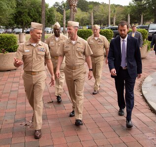 Naval Information Warfare Center Atlantic Commanding Officer Capt. Wesley Sanders, left, chats with Chief of Naval Operations Adm. John Richardson, center, as the CNO and NIWC Atlantic leadership team walk to the main engineering center.