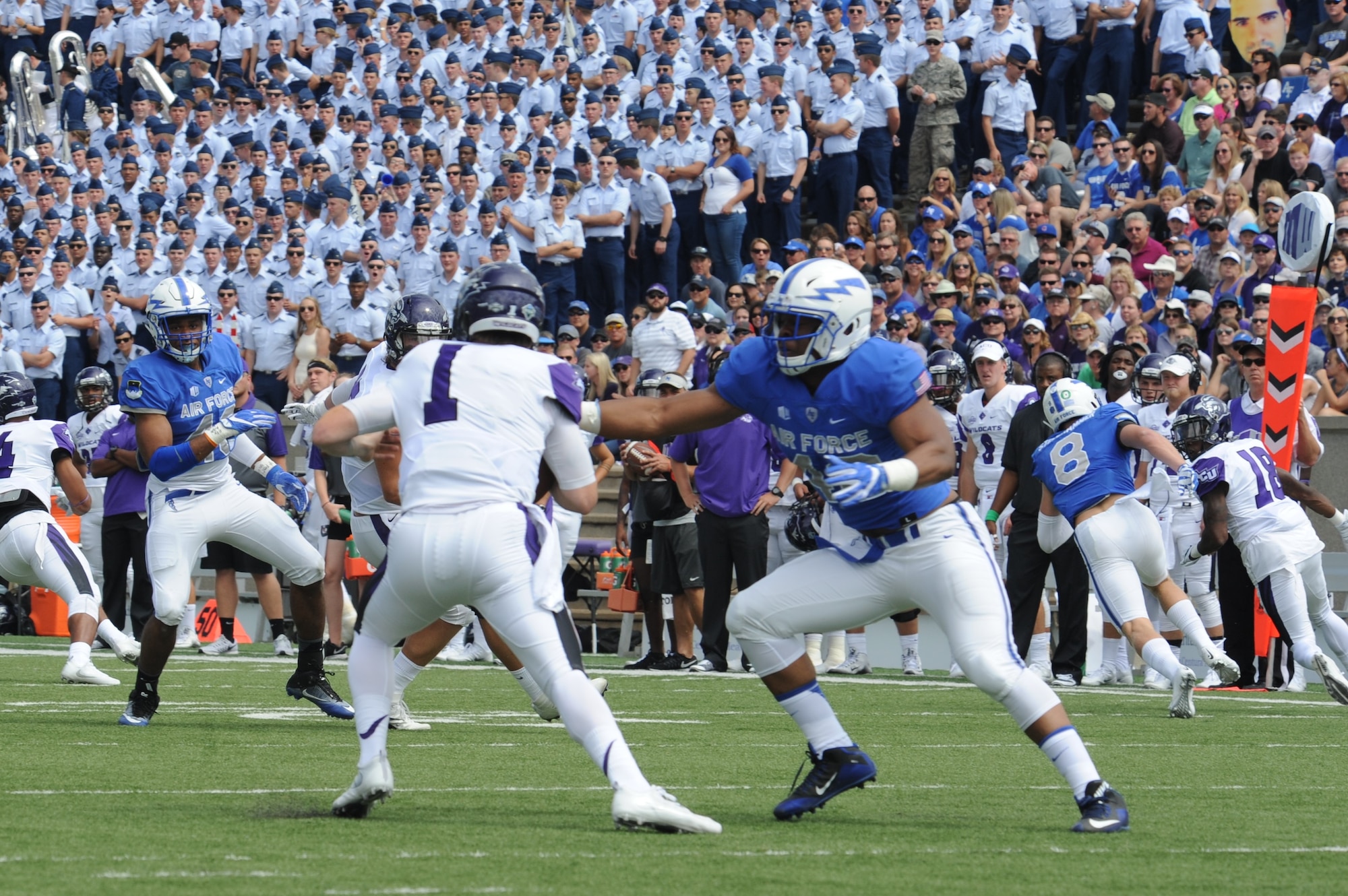 Air Force Academy Defensive End Ryan Watson, right, grabs Abilene Christian University quarterback Dallas Sealey for an eventual sack in this Sept. 3, 2016 game. Watson registered 14.5 sacks in four seasons at defensive end and outside linebacker at the Academy, and was offered a free agent contract with the Arizona Cardinals in 2017. Now a program manager with AFLCMC, Watson has been invited to the Detroit Lions rookie minicamp, May 10-13. (U.S. Air Force photo/John Van Winkle).