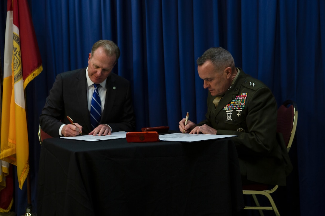 Maj Gen. Vincent A. Coglianese, commanding general, Marine Corps Installations Command, right, with Kevin L. Faulconer, mayor of San Diego, left, signs the Memorandum of Understanding (MOU) for the Smart City initiatives between the Marine Corps and the City of San Diego at San Diego City Hall, Feb. 21. The MOU 

highlighted on technological development geared toward improving Marine Corps Air Station Miramar and the city of San Diego such as unmanned aircraft systems (UAS), smart street lights, renewable energy and the City’s “Get It Done” application. (U.S. Marine Corps photo by LCpl Cheng Chang)