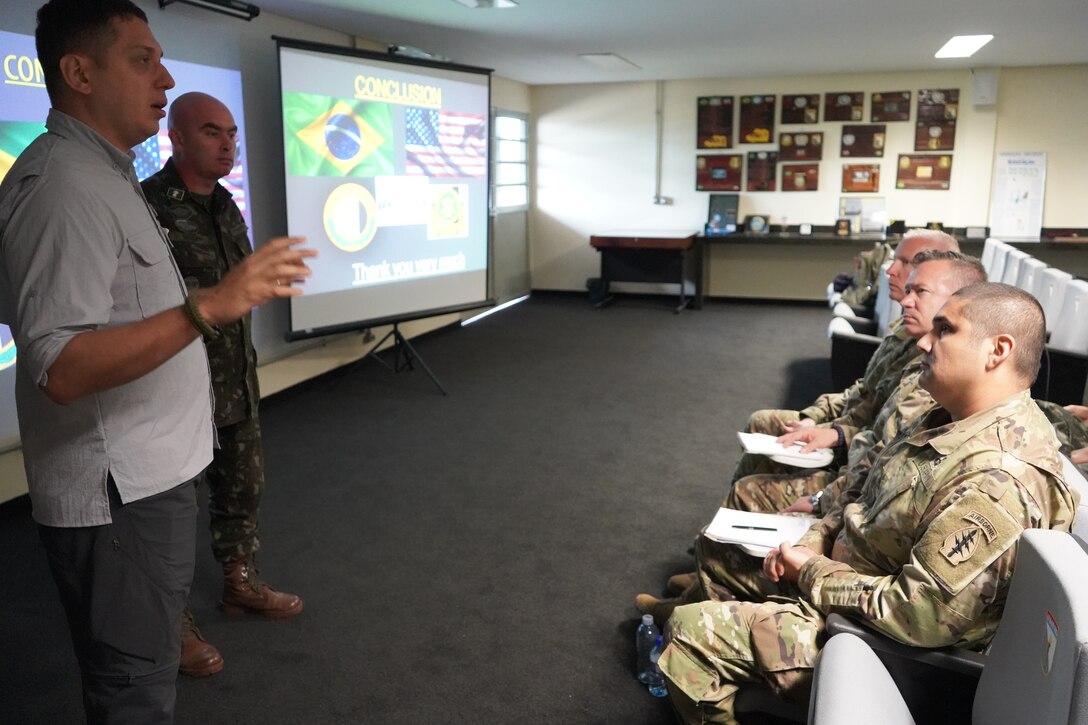 SOCSOUTH service members listen to a Brazilian translator during during a subject matter expert exchange with the Brazilian Army 1st Psychological Operations Battalion held in Goiânia, Brazil, April 15-19, 2019.